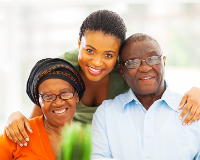 caregiver and two elderly smiling